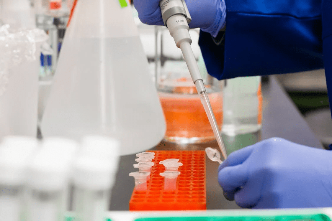 Scientist holding a pipette, testing samples