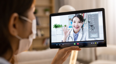 Telemedicine concept -  asian female patient listening to doctor talking symptom on the internet and make a discussion with ok gesture